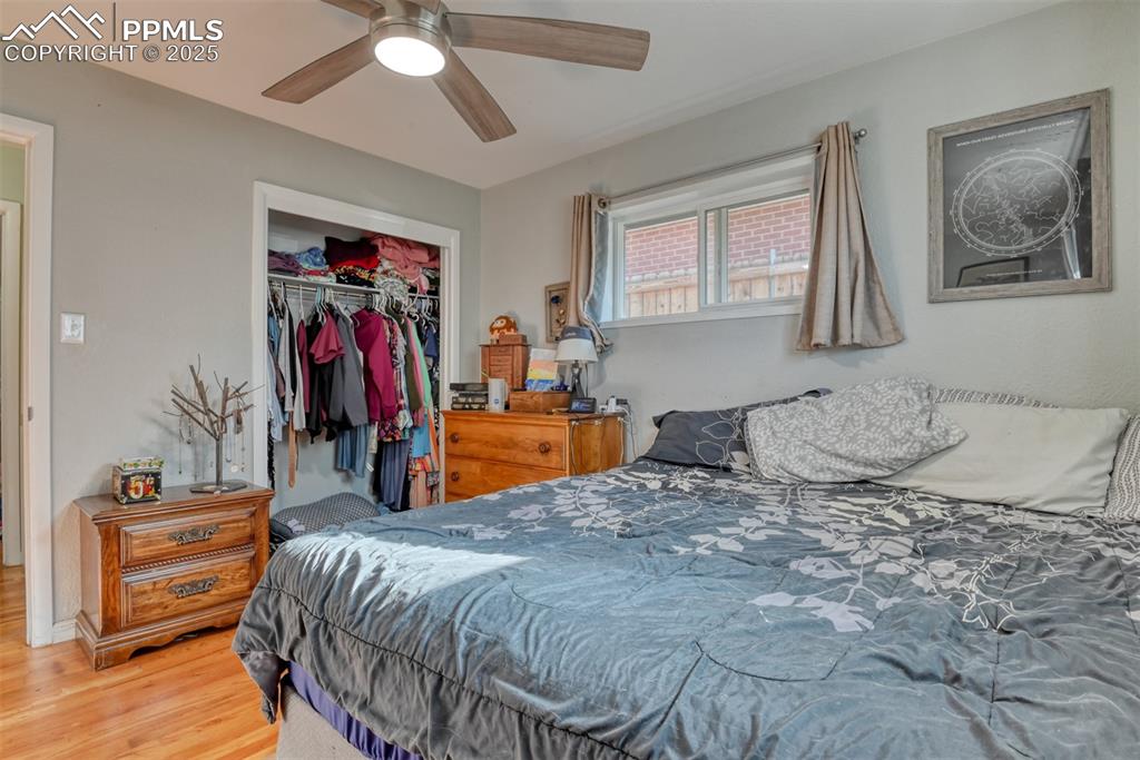 Image 21 of 45: Bedroom featuring wood finished floors, a closet, and ceiling fan