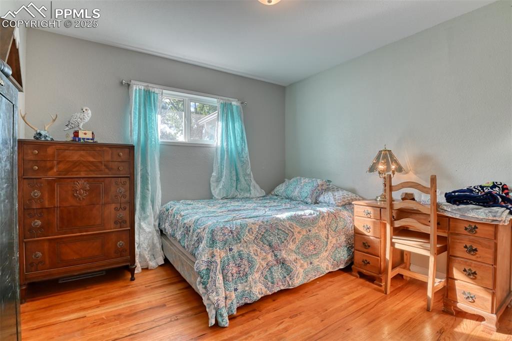 Image 23 of 45: Bedroom with light wood-style flooring