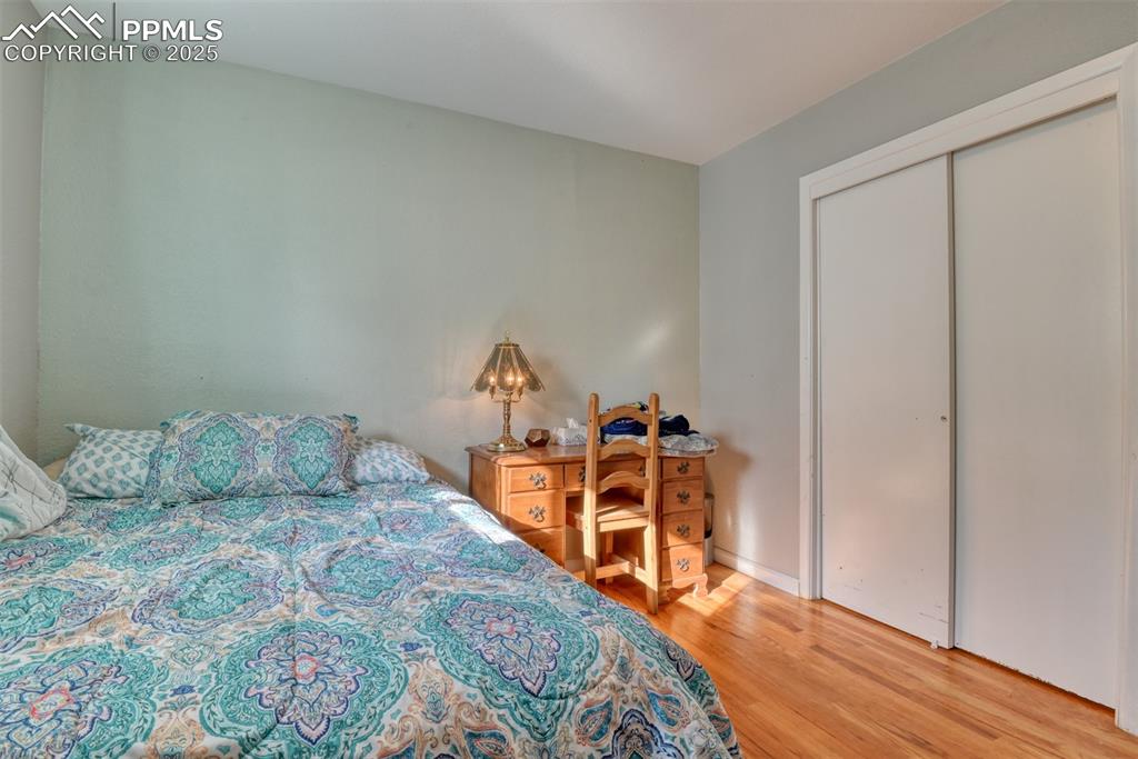 Image 24 of 45: Bedroom featuring light wood finished floors and a closet