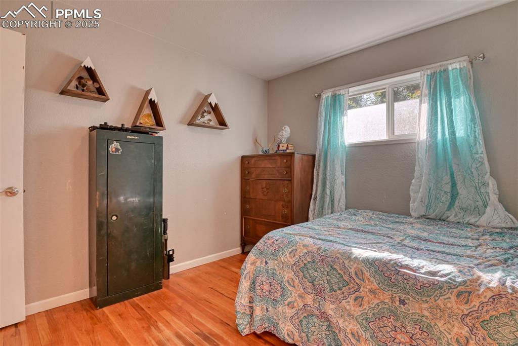 Image 25 of 45: Bedroom with baseboards and wood finished floors