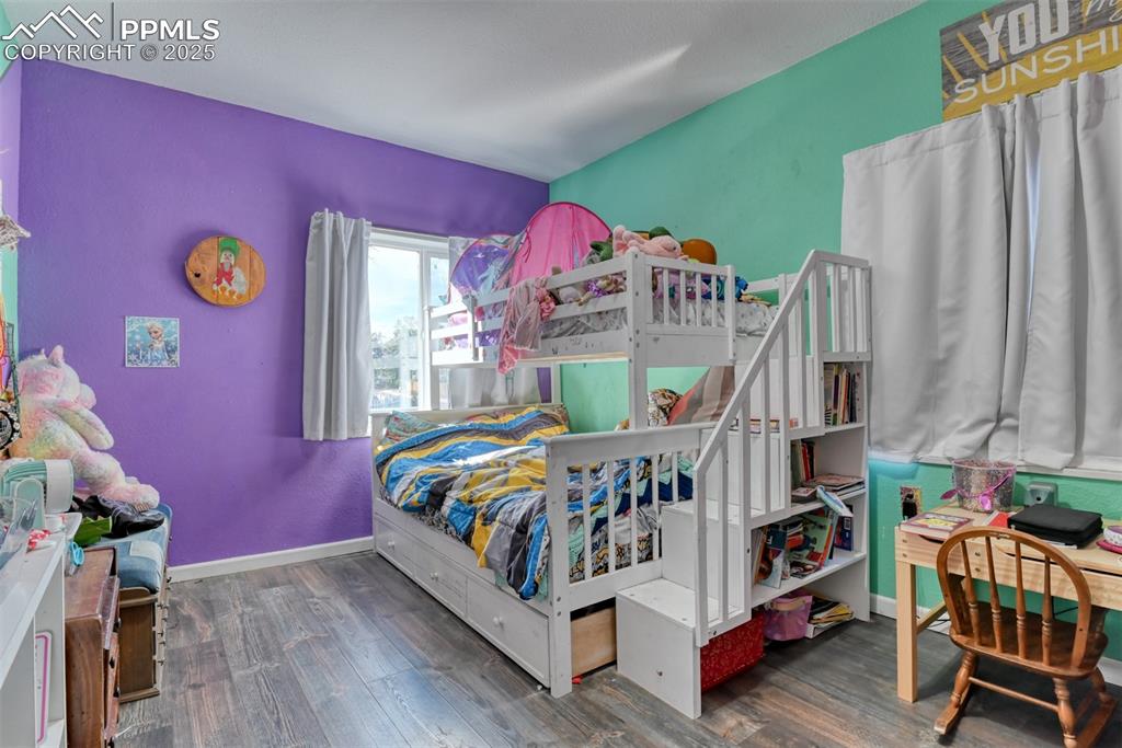 Image 29 of 45: Bedroom featuring dark wood-type flooring and baseboards