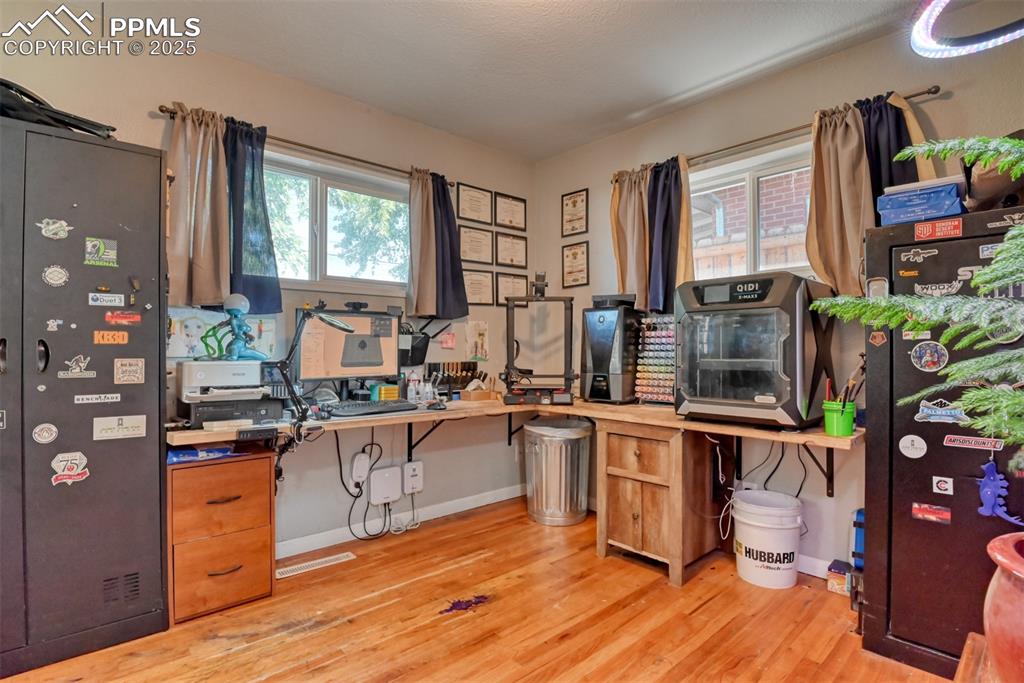Image 31 of 45: Office featuring light wood-style flooring and healthy amount of natural li