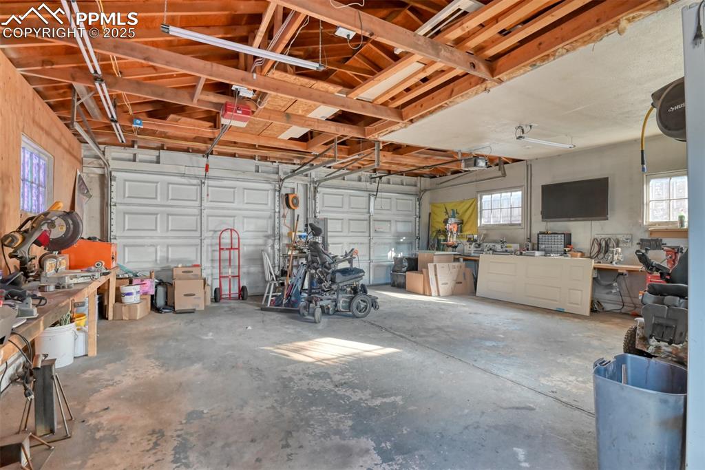 Image 42 of 45: Garage with a workshop area