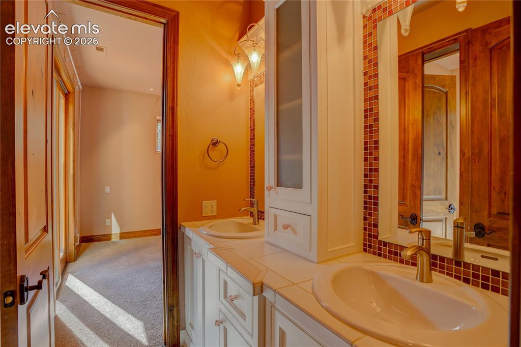 Image 38 of 50: Full bath connecting 2nd and 3rd bedrooms.