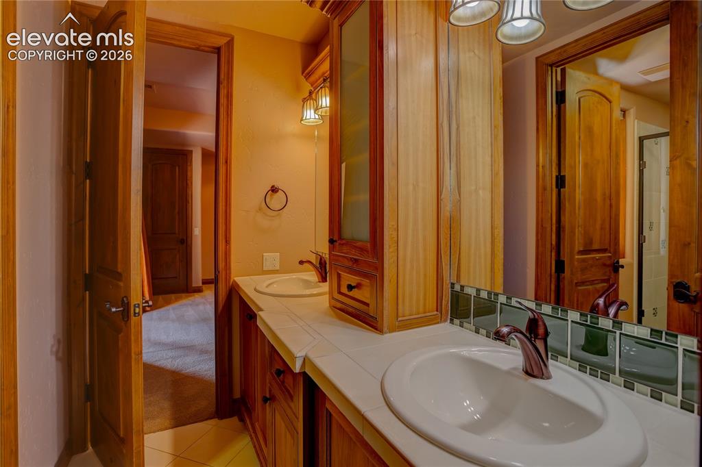 Image 43 of 50: Full bath connecting 4th and 5th bedrooms.