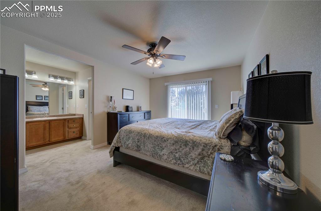 Image 19 of 49: Bedroom featuring light colored carpet and a ceiling fan