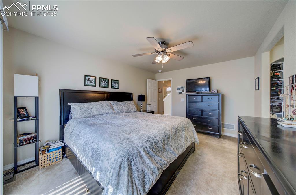 Image 21 of 49: Bedroom featuring light colored carpet and a ceiling fan