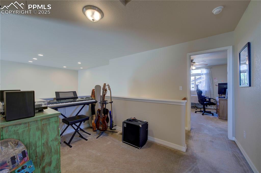 Image 28 of 49: Office area featuring light colored carpet and recessed lighting