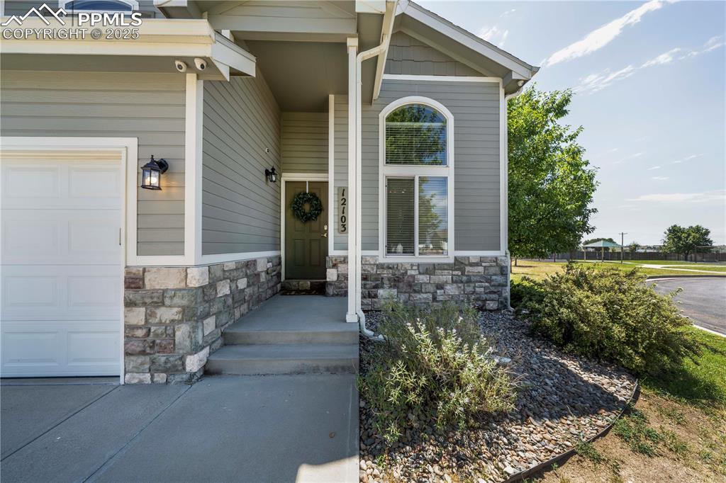 Image 3 of 49: View of exterior entry with stone siding