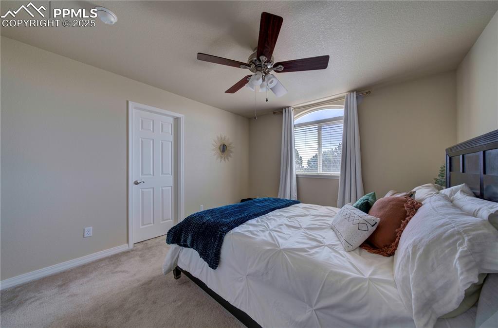 Image 30 of 49: Bedroom featuring carpet floors, ceiling fan, and a textured ceiling