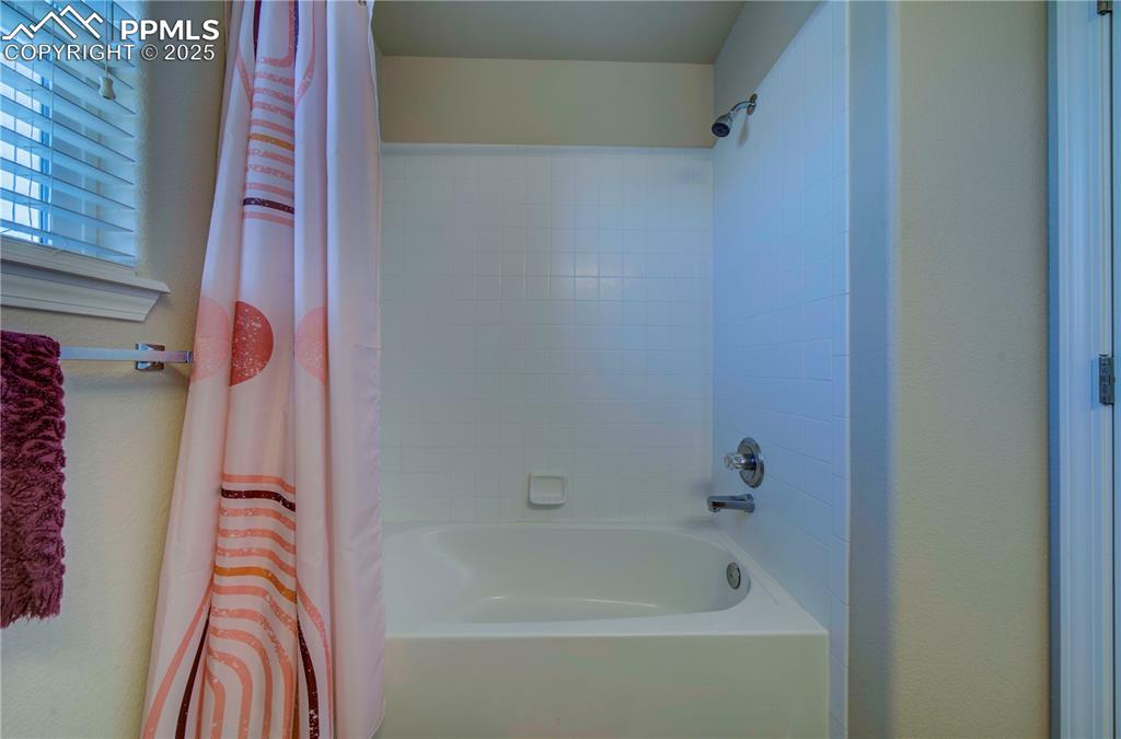 Image 37 of 49: Full bath featuring shower / bath combo with shower curtain