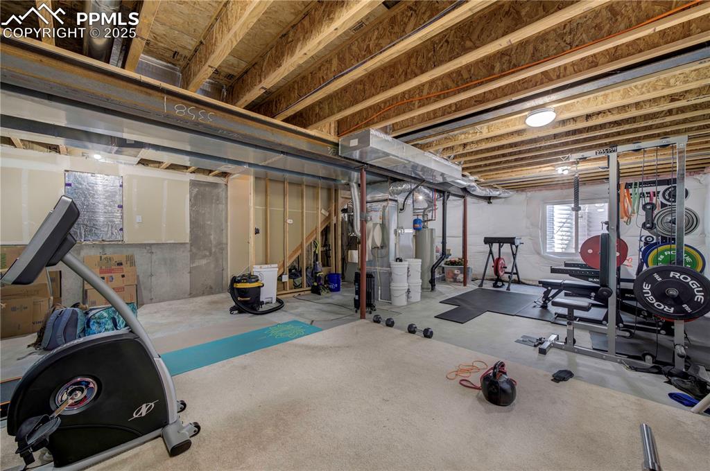 Image 41 of 49: Exercise area with gas water heater