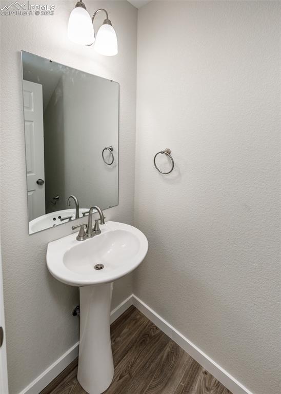Image 22 of 45: Bathroom featuring dark wood-style flooring and a textured wall
