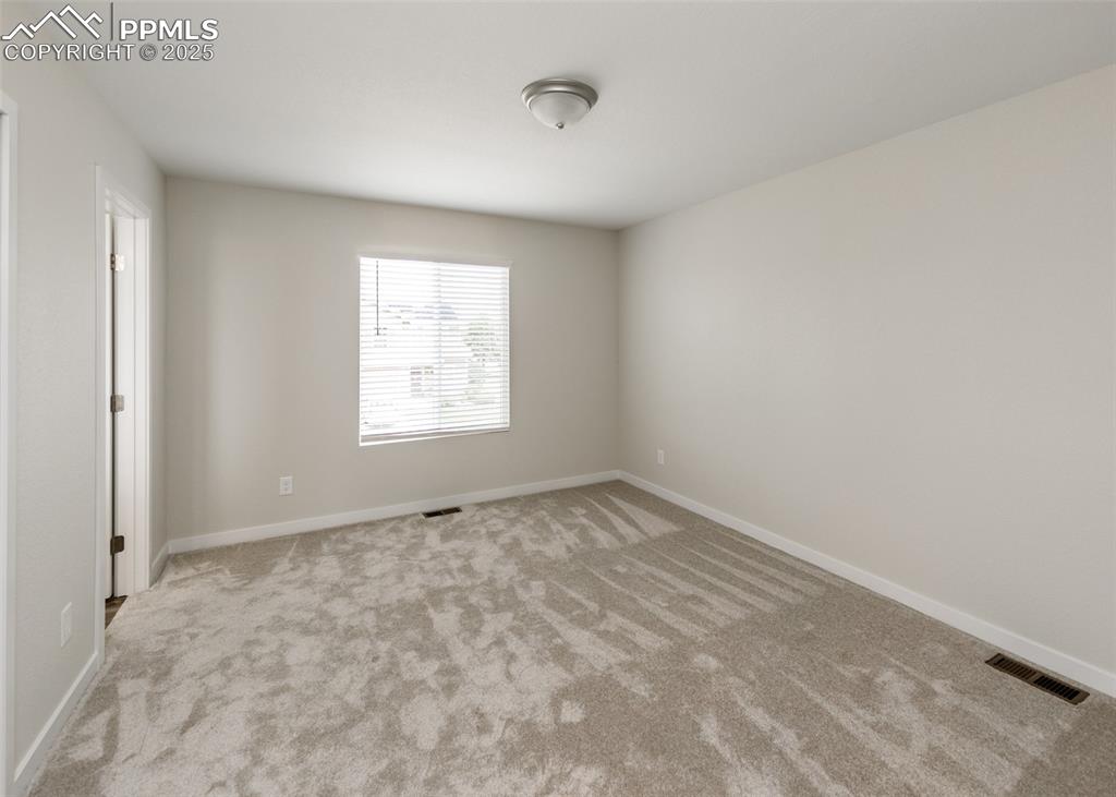 Image 23 of 45: Empty room with carpet floors and baseboards