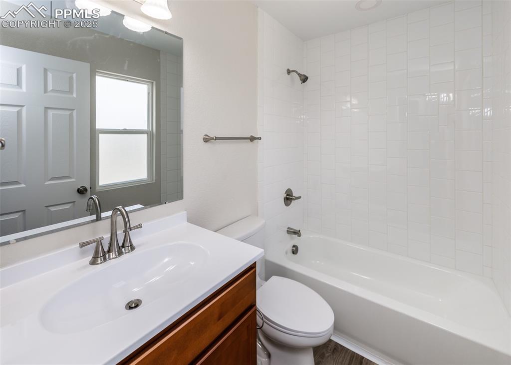 Image 27 of 45: Bathroom with tub / shower combination and vanity