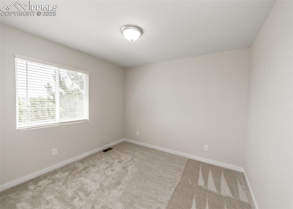 Image 32 of 45: Spare room with carpet and baseboards