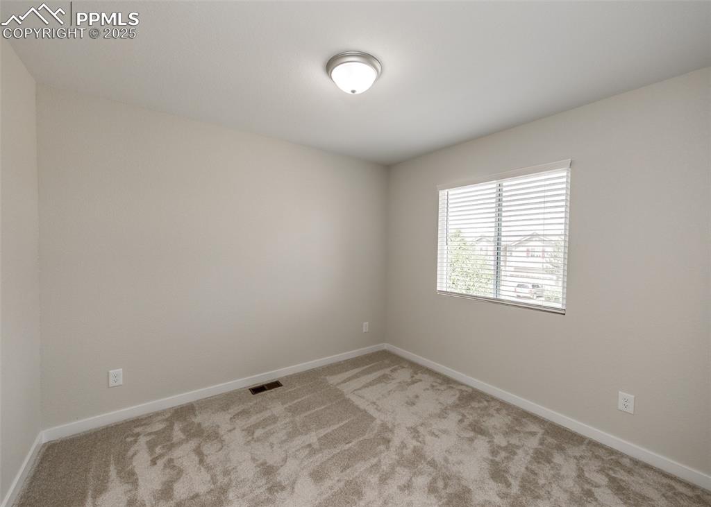 Image 34 of 45: Carpeted spare room with baseboards