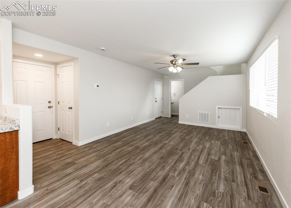 Image 4 of 45: Bonus room featuring dark wood-style floors and ceiling fan