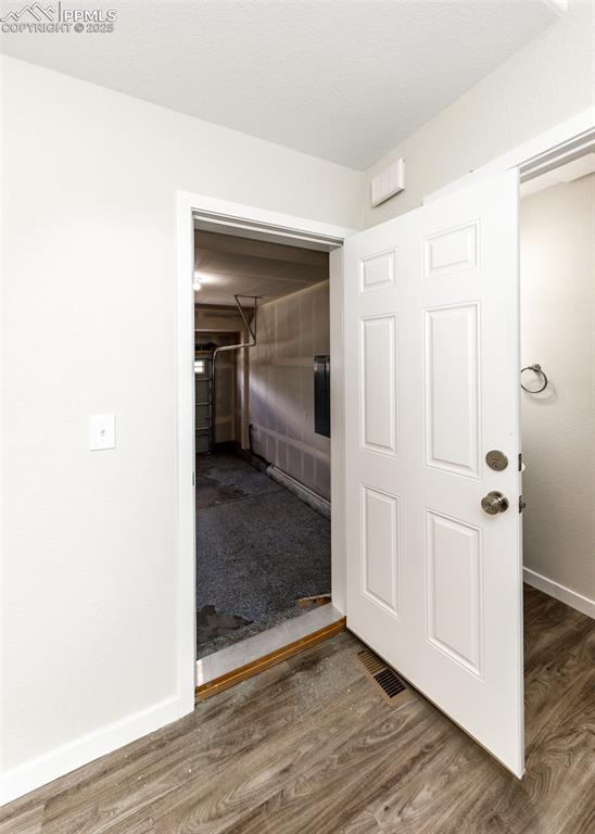 Image 43 of 45: Hallway with baseboards and wood finished floors