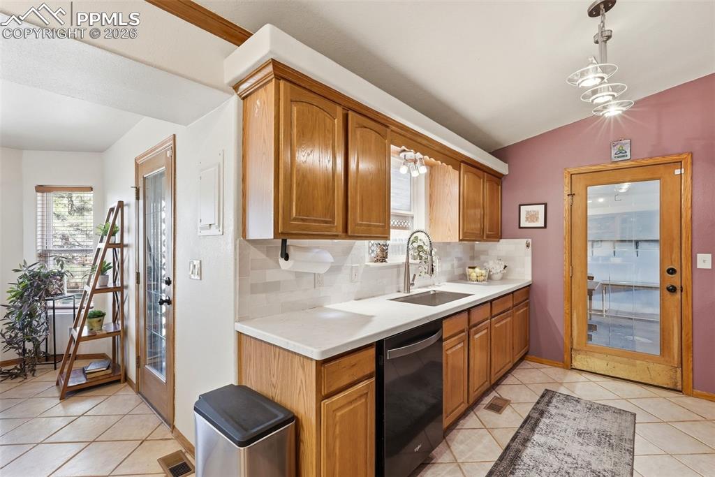 Image 12 of 50: Subway Tile, Tile Floors, Stone Counter Tops, Garage Access, Black Stainles