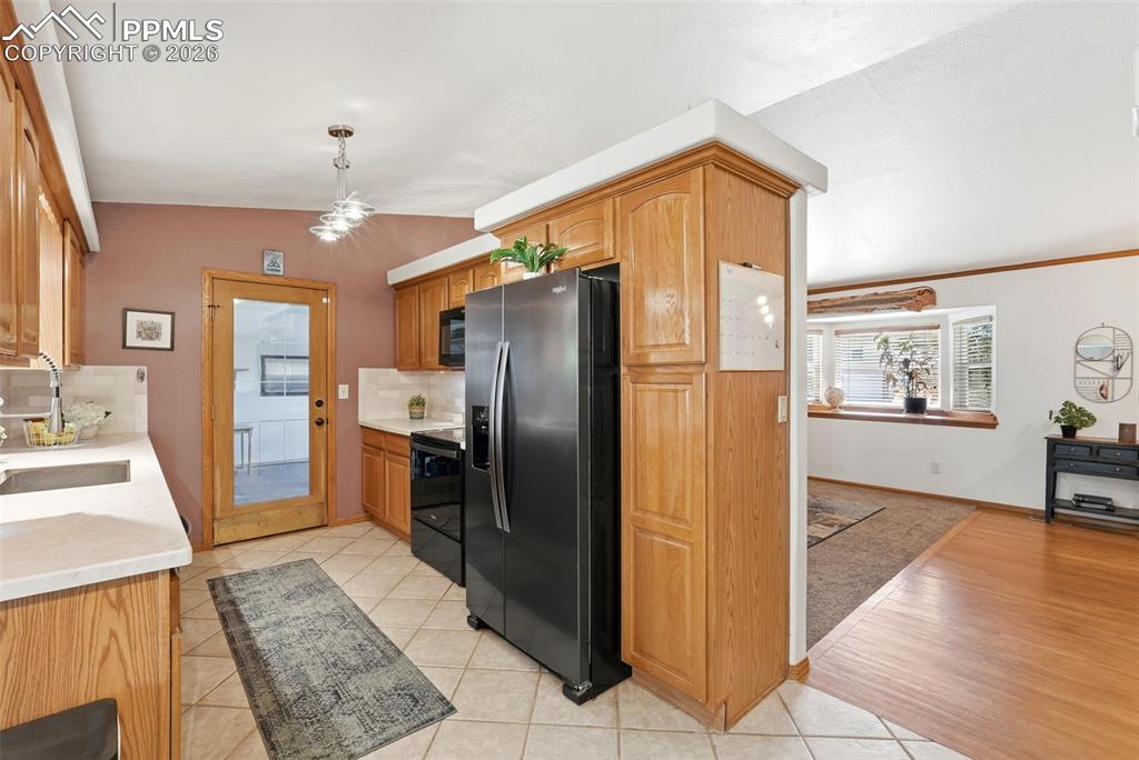 Image 14 of 50: Subway Tile, Tile Floors, Stone Counter Tops, Garage Access, Black Stainles
