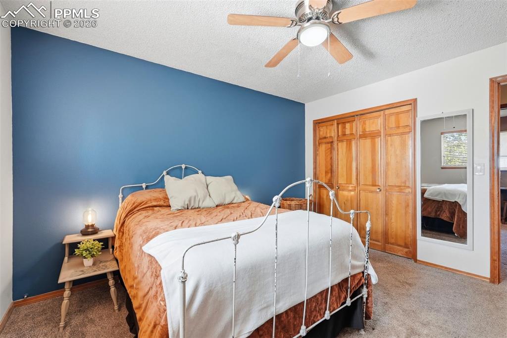 Image 26 of 50: Carpet, Ceiling Fan, Walk In Closet, Bathroom Access, Wood Doors And Closet