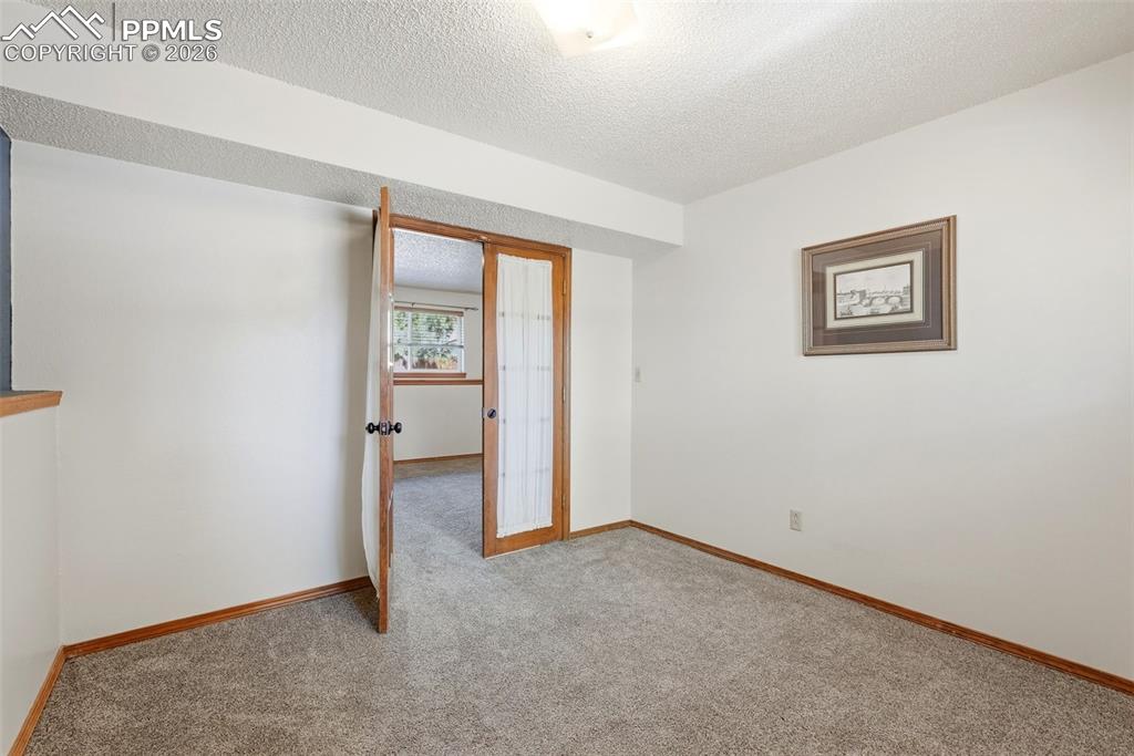 Image 37 of 50: Lower Level, Carpet, French Doors