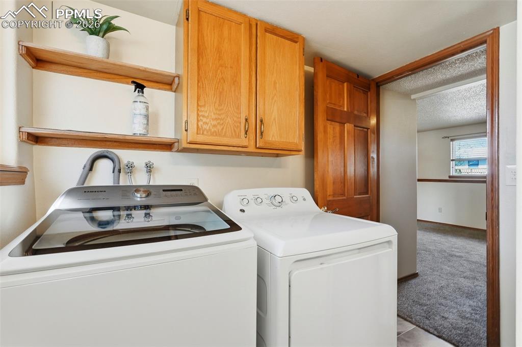 Image 40 of 50: Lower Level, Bathroom, Shower, Laundry, Tile, Window