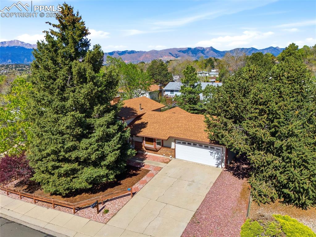Image 5 of 50: Front Of Treed Structure With Mountains