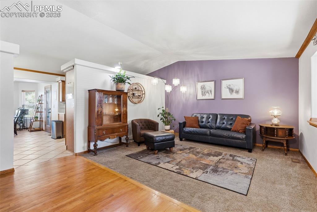 Image 6 of 50: Wood Floors, Vaulted Ceiling, Bay Window, Carpet, Built-Ins, Coat Closet