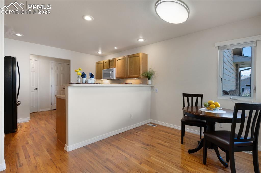 Image 14 of 38: Kitchen featuring freestanding refrigerator, light wood-style flooring, a p