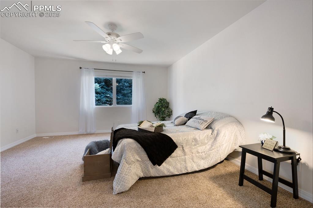 Image 18 of 38: Carpeted bedroom featuring ceiling fan and baseboards
