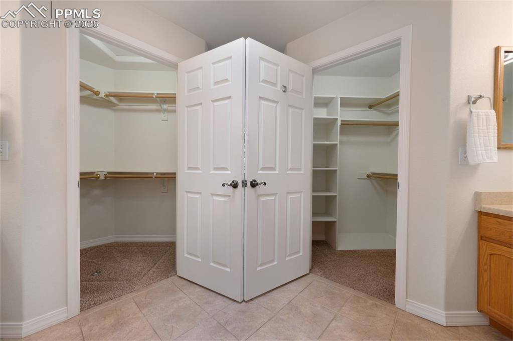 Image 24 of 38: Spacious closet with light tile patterned floors