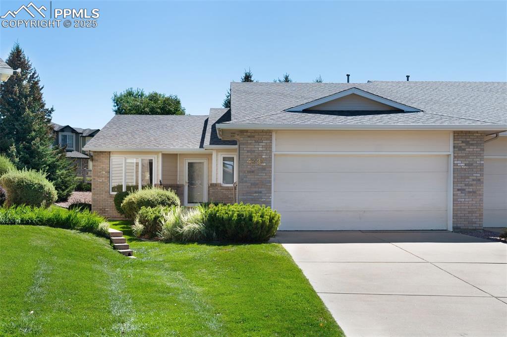 Image 35 of 38: Ranch-style home with brick siding, a front yard, and roof with shingles