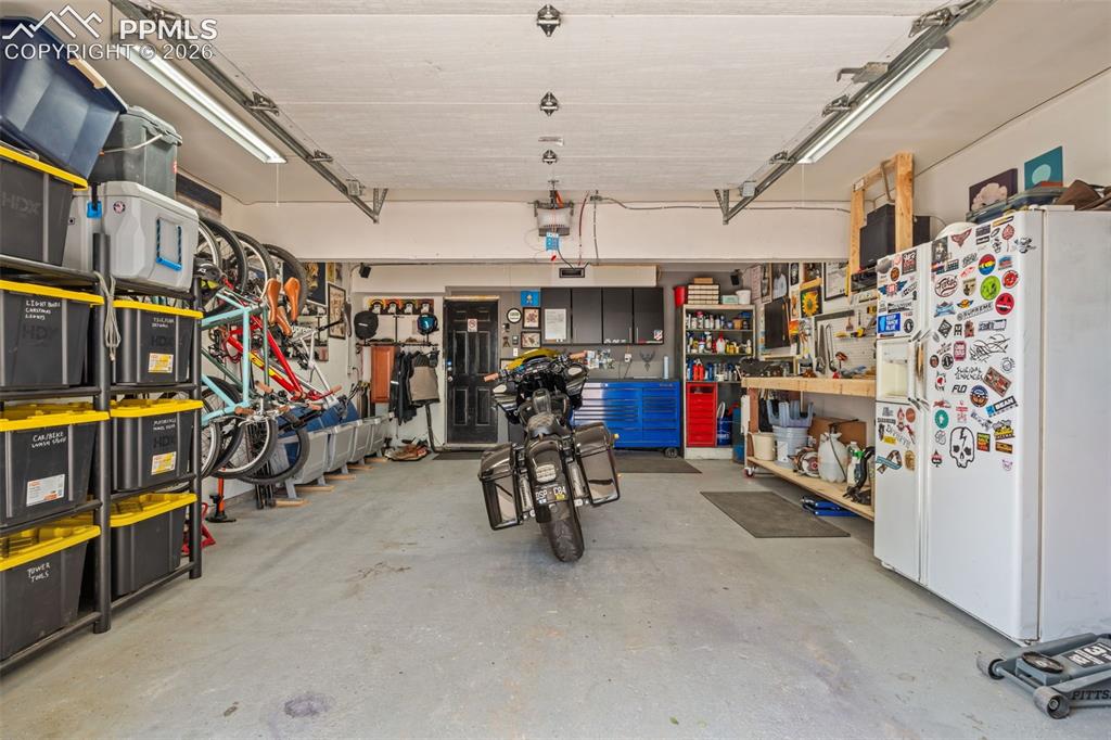 Image 27 of 34: Oversized garage with room for storage and workshop