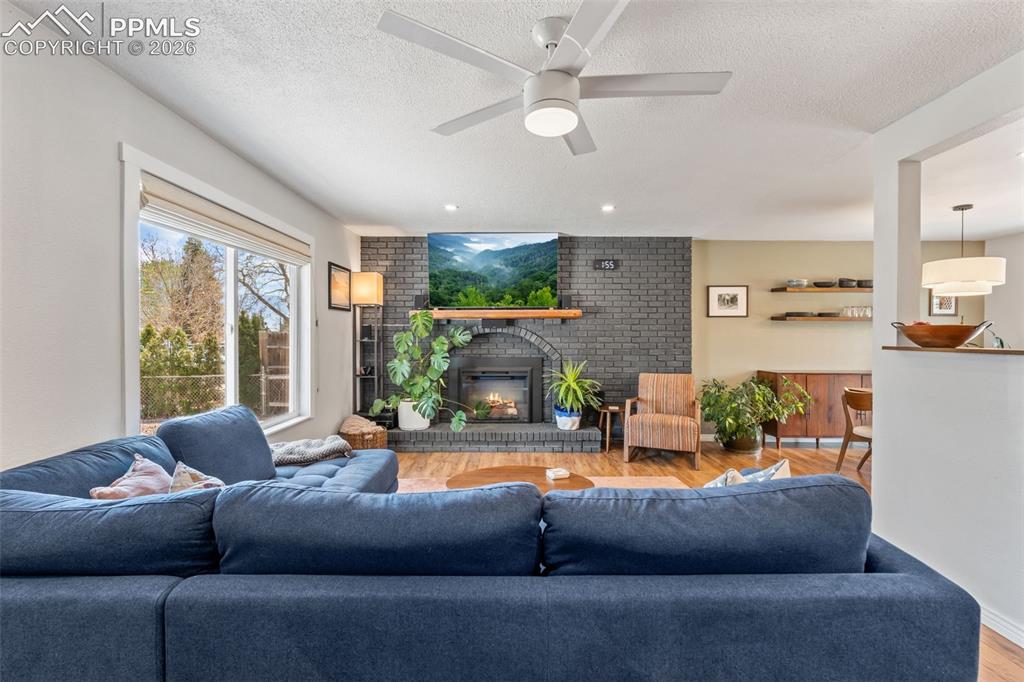 Image 4 of 34: Brick Fireplace is woodburning with electric insert
