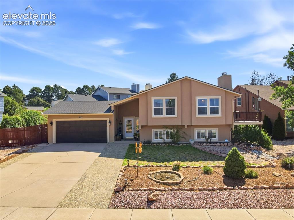 Image 1 of 37: Multi-level home featuring a stucco exterior, attached two-car garage, and