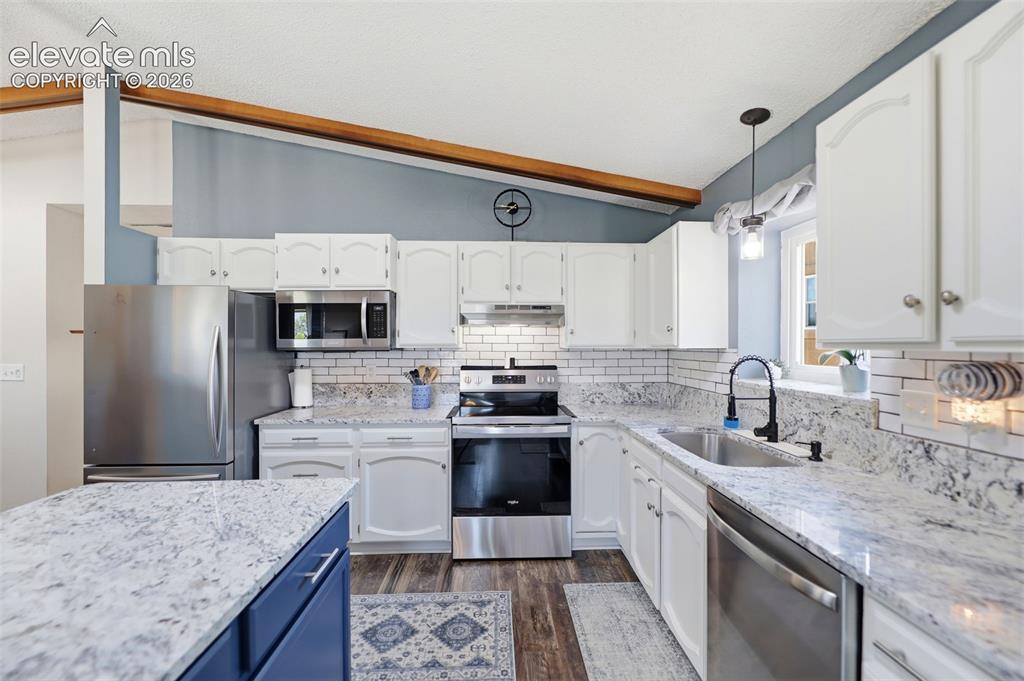 Image 11 of 37: Beautifully updated kitchen including fresh paint, new countertops and back