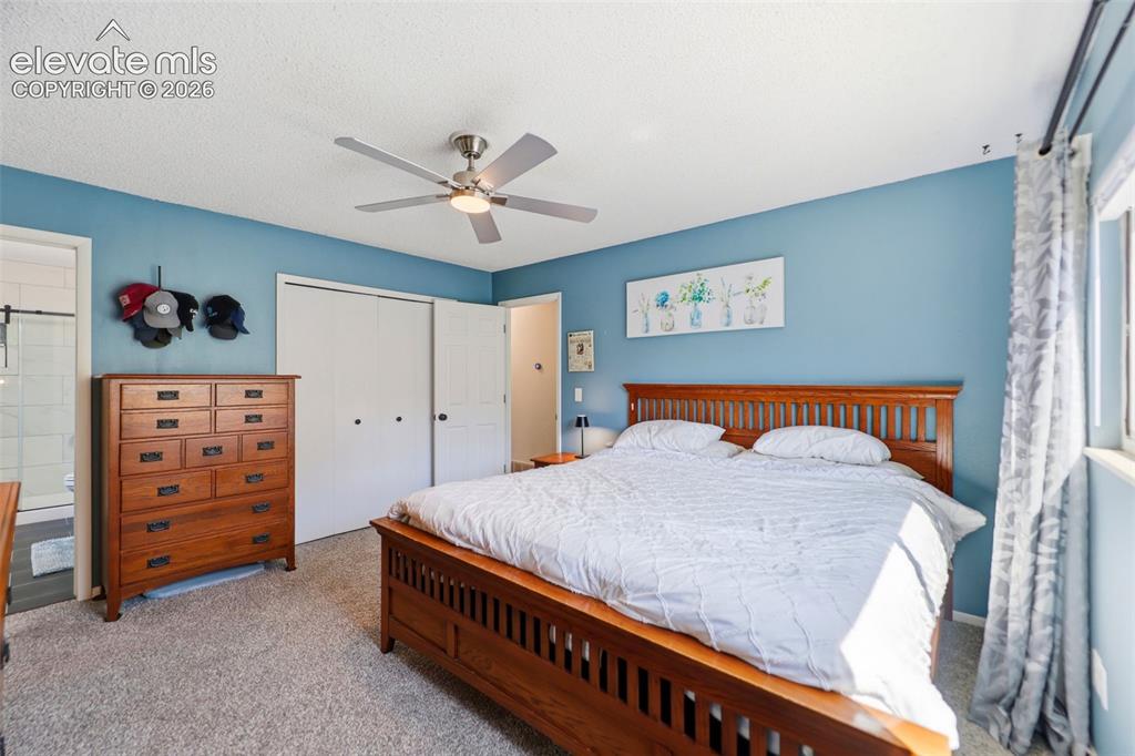 Image 16 of 37: Carpeted room featuring a ceiling fan with integrated lighting, a window wi