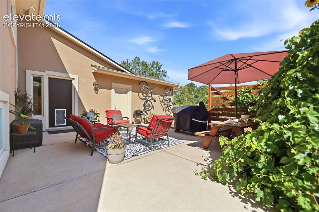 Image 30 of 37: Expansive concrete patio area offering multiple zones for outdoor enjoyment
