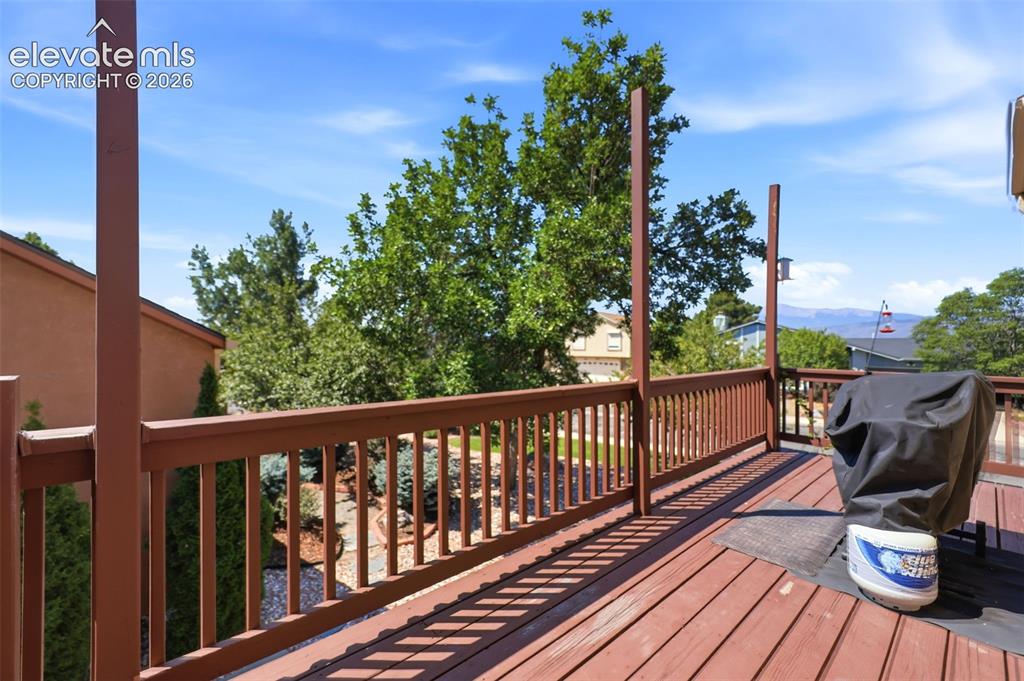 Image 34 of 37: Deck off of the kitchen/dining rooms with views of Pikes Peak