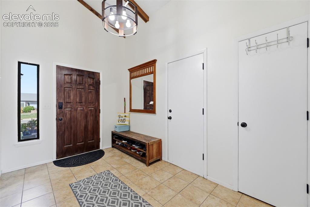 Image 5 of 37: Large entry featuring access to the garage, and a walk out to the beautiful