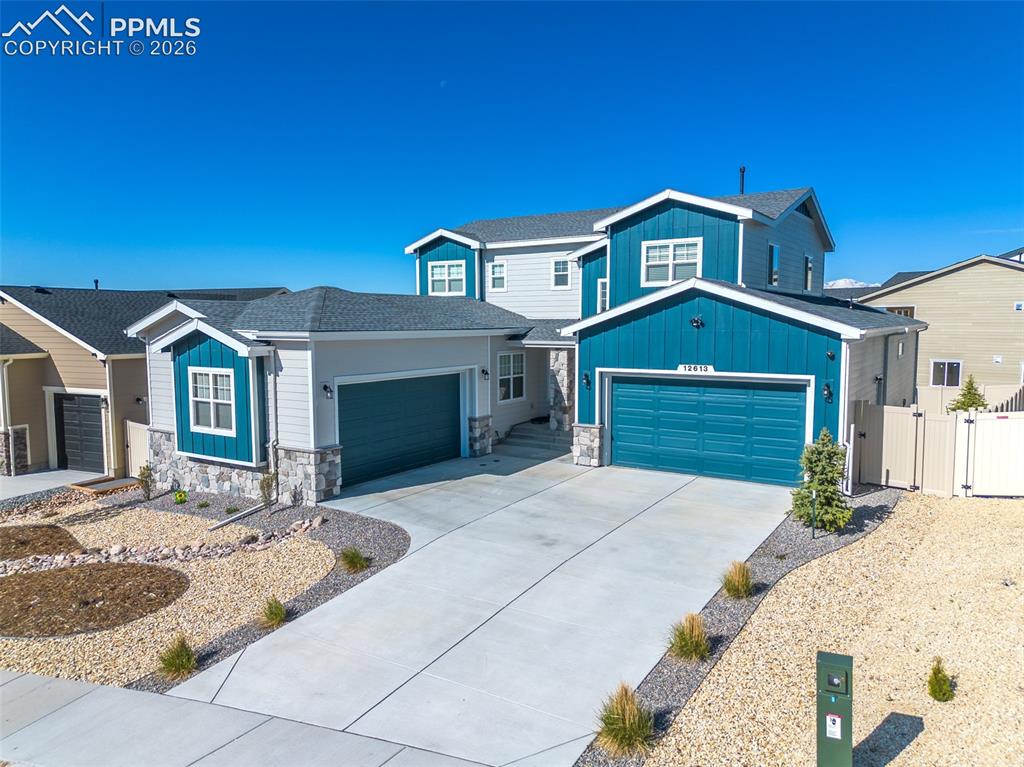 Image 1 of 9: Contemporary two-story residence featuring a two-tone exterior with blue si