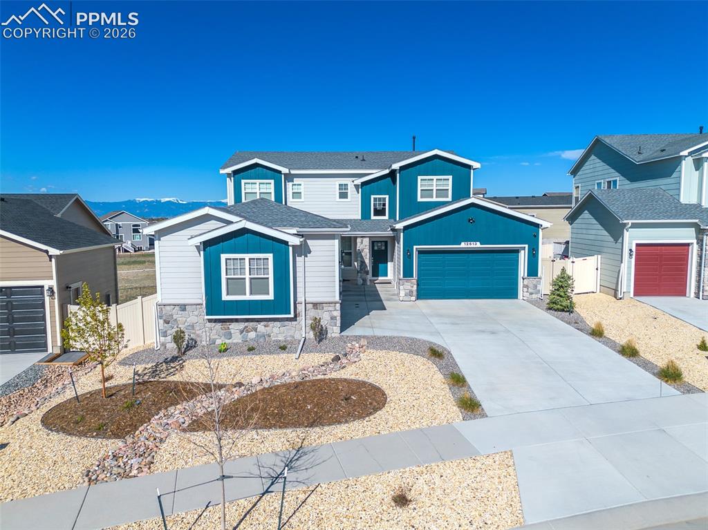 Image 2 of 9: Contemporary multi-story residence featuring a striking blue and gray exter