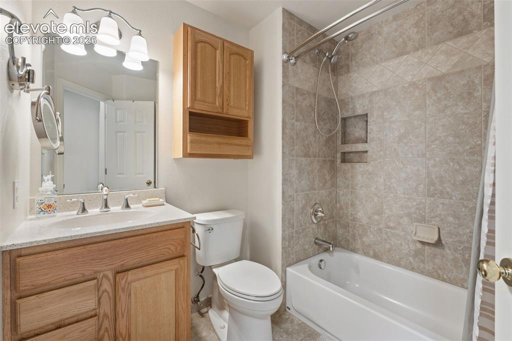 Image 28 of 50: Upper Hallway full bath, spacious with tile shower.
