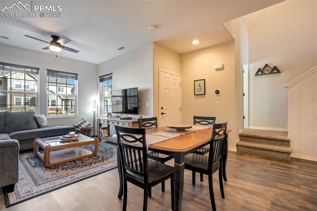 Image 11 of 48: Dining area open to the living area.  Showing the front door and two steps 