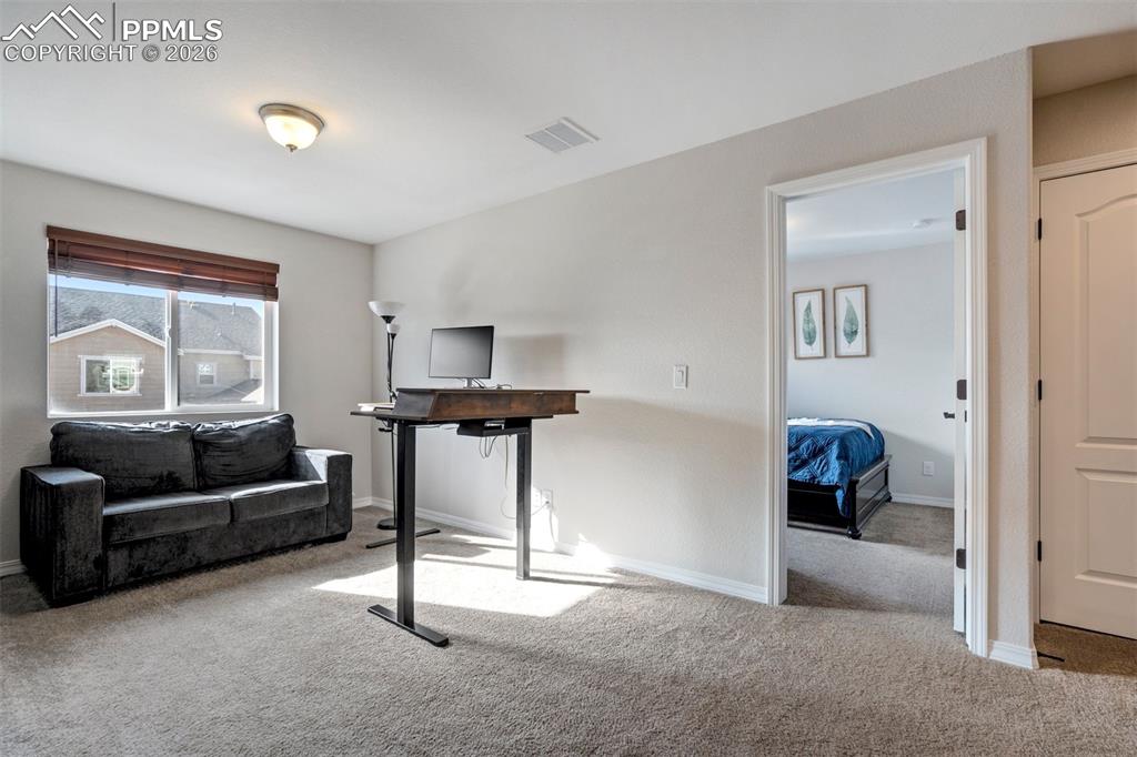 Image 21 of 48: Light filled flexible Loft space.  Door to the second bedroom.