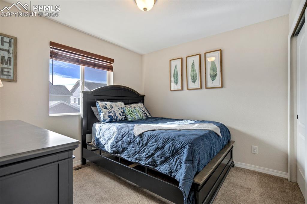 Image 31 of 48: Light filled second bedroom, with large closet.