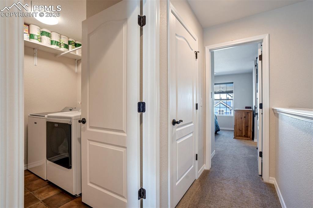Image 36 of 48: Laundry room with washer and dryer, included and tile floor. 