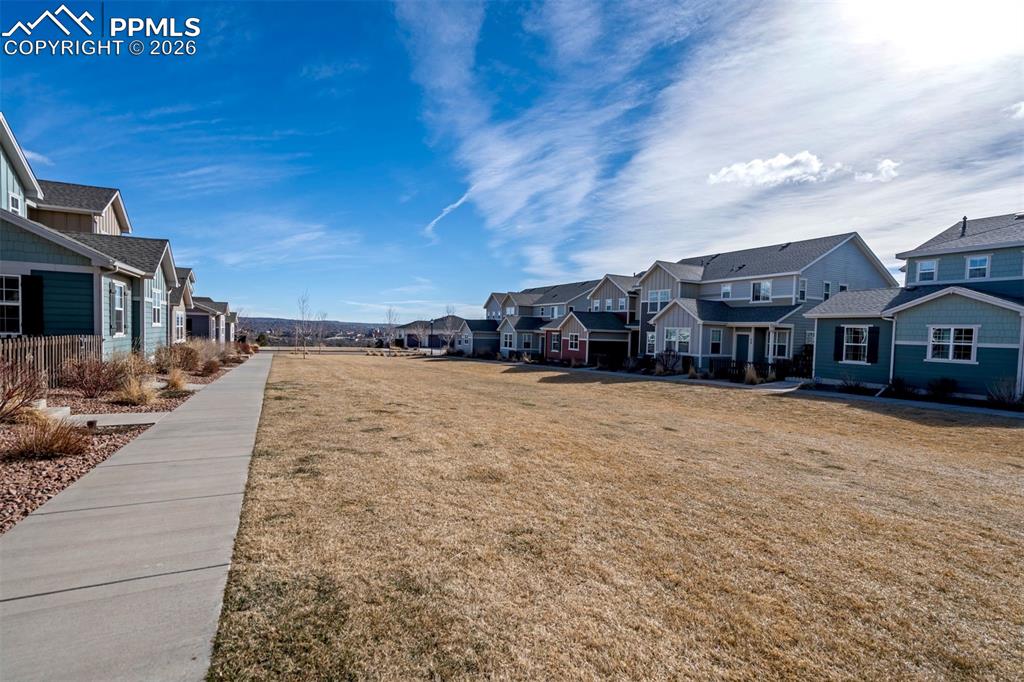 Image 37 of 48: View of the greenbelt area outside the townhome.  